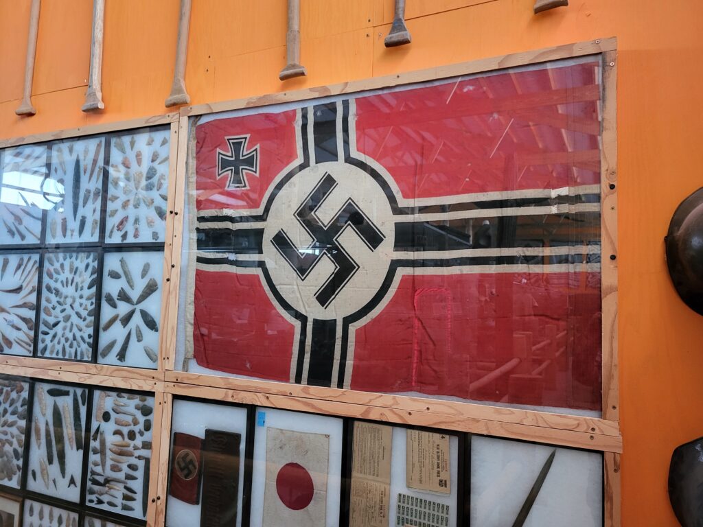 Collection of arrowheads and World War II flags, including a Nazi flag, at Idaho's Mammoth Cave and Shoshone Bird Museum