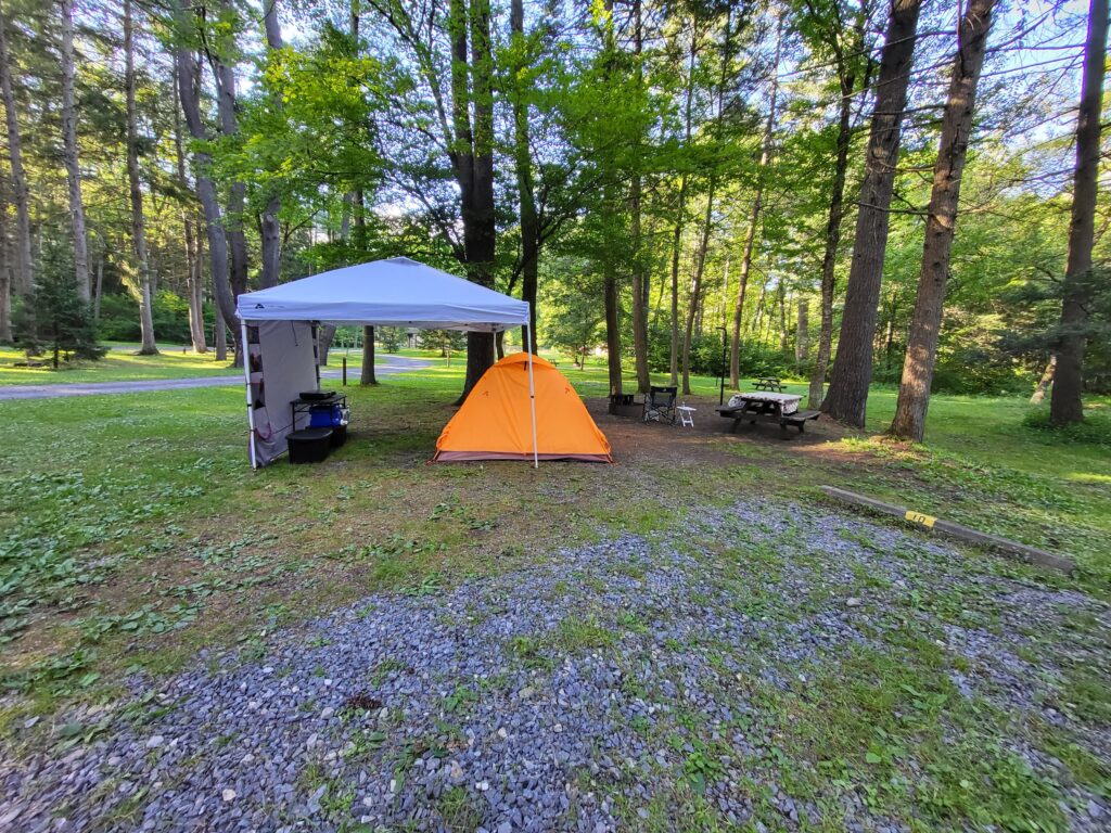 Canopy, tent, and picnic table set up at Hyner Run State Park Campground